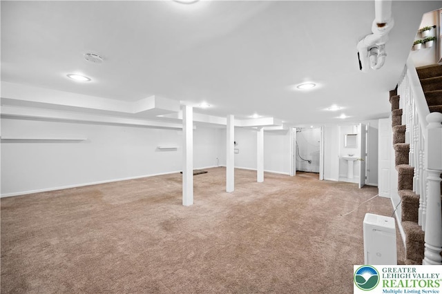 finished basement with stairway, carpet, and baseboards