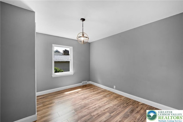 empty room with wood finished floors and baseboards
