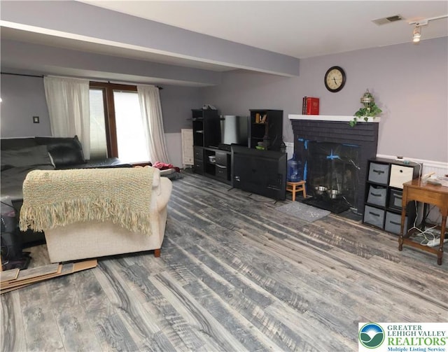 living area with wood finished floors and a fireplace