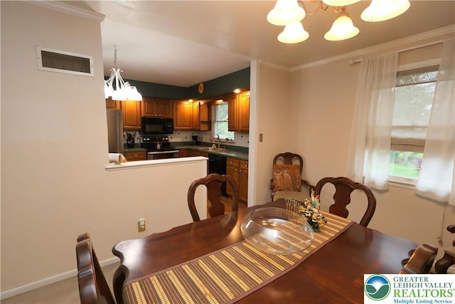 dining area featuring a chandelier, plenty of natural light, and ornamental molding
