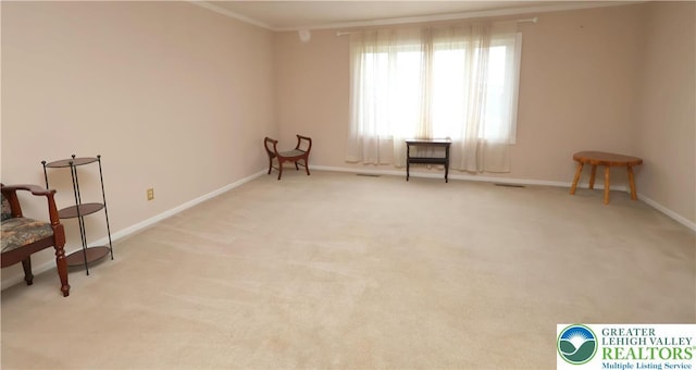 unfurnished room featuring ornamental molding, carpet, and baseboards