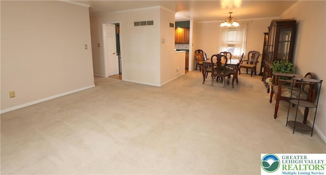 dining room featuring a chandelier, crown molding, baseboards, and light colored carpet