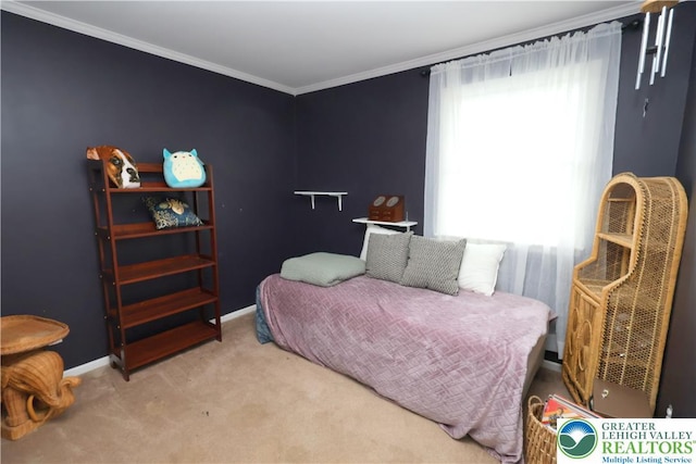 carpeted bedroom with ornamental molding and baseboards