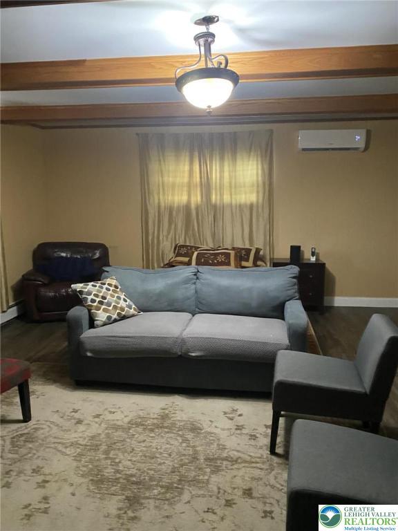 3516 Pine Ave, Saint Lawrence, PA 19606 - living room featuring a wall mounted AC, wood finished floors, and baseboard heating