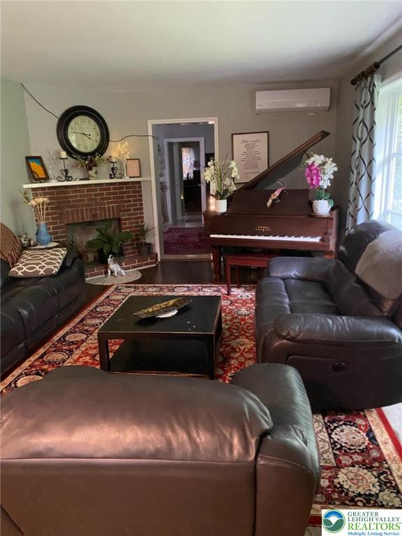 3516 Pine Ave, Saint Lawrence, PA 19606 - living room with a wall unit AC and a brick fireplace