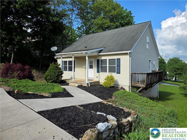 view of front of property with covered porch and a shingled roof