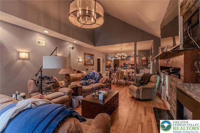 803 Birch Ave, Pen Argyl Borough, PA 18072 - living area with a chandelier, high vaulted ceiling, wood finished floors, a fireplace, and recessed lighting