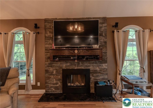 803 Birch Ave, Pen Argyl Borough, PA 18072 - living area with a stone fireplace, wood finished floors, and baseboards