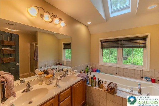 803 Birch Ave, Pen Argyl Borough, PA 18072 - full bathroom featuring a garden tub, double vanity, a shower stall, a skylight, and lofted ceiling