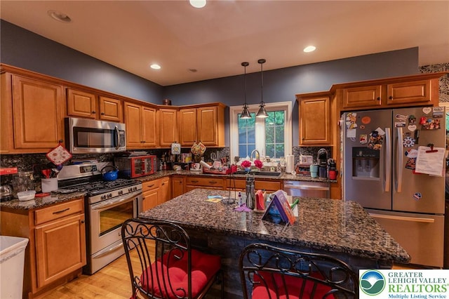 803 Birch Ave, Pen Argyl Borough, PA 18072 - kitchen with stainless steel appliances, a sink, brown cabinets, backsplash, and recessed lighting