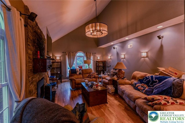 803 Birch Ave, Pen Argyl Borough, PA 18072 - living area featuring high vaulted ceiling, a chandelier, wood finished floors, and a fireplace