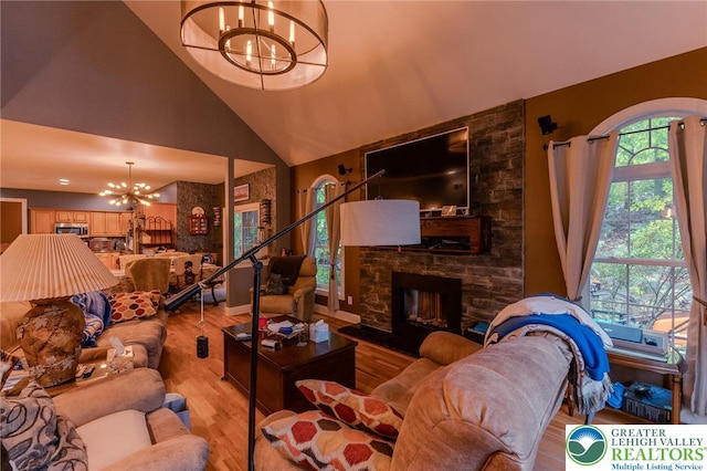 803 Birch Ave, Pen Argyl Borough, PA 18072 - living area featuring a chandelier, light wood-style flooring, high vaulted ceiling, and a stone fireplace