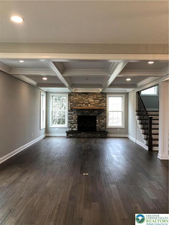4129 Meadow View Dr, Lower Nazareth Twp, PA 18020 - unfurnished living room featuring stairs, coffered ceiling, baseboards, a stone fireplace, and dark wood-style floors