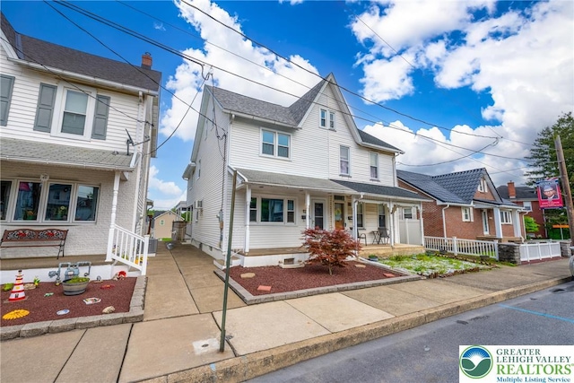 townhome / multi-family property with covered porch and fence