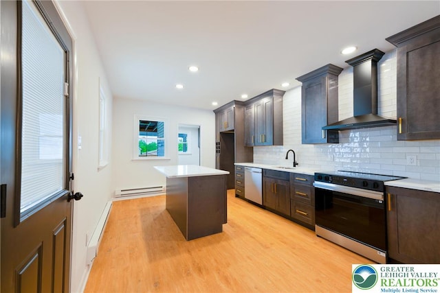 kitchen featuring black range with electric stovetop, wall chimney exhaust hood, a sink, dishwasher, and baseboard heating