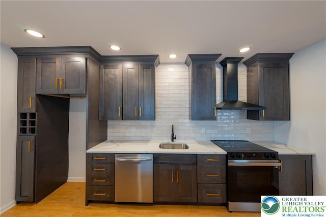 kitchen with electric range oven, dishwasher, wall chimney range hood, a sink, and light countertops