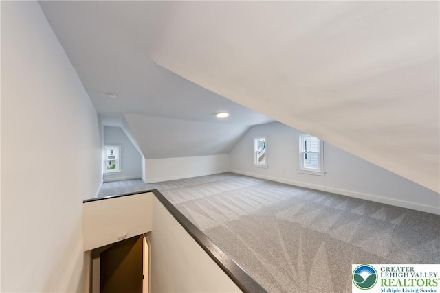 bonus room featuring baseboards, carpet flooring, and vaulted ceiling
