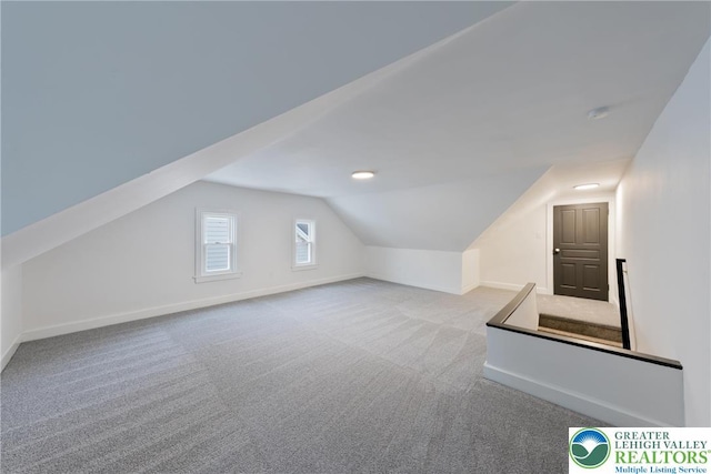 bonus room featuring carpet flooring, vaulted ceiling, and baseboards
