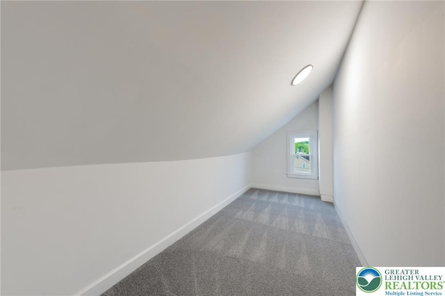 bonus room with carpet, vaulted ceiling, and baseboards