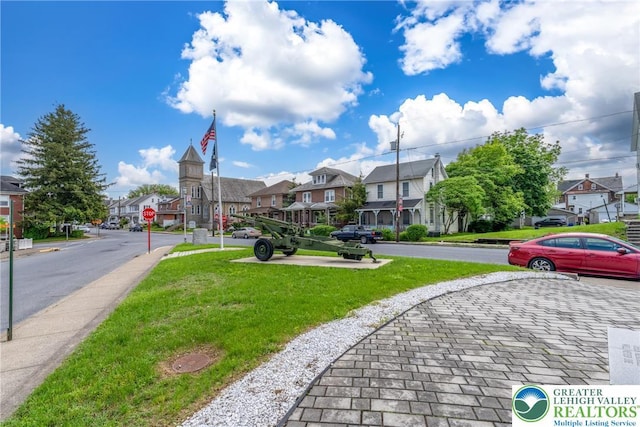 surrounding community featuring a residential view and a yard