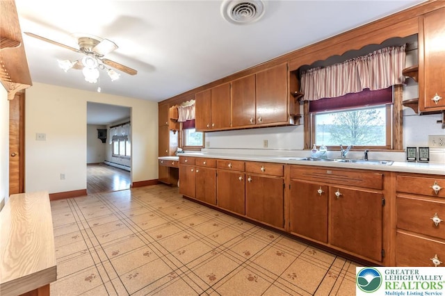 1195 Hemlock St, Lower Towamensing Tp, PA 18071 - kitchen featuring a sink, light countertops, a ceiling fan, and brown cabinets