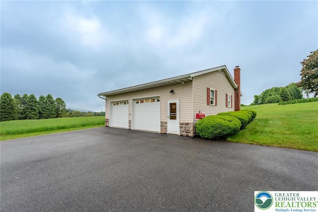 1195 Hemlock St, Lower Towamensing Tp, PA 18071 - view of property exterior featuring a chimney, a yard, stone siding, and a garage