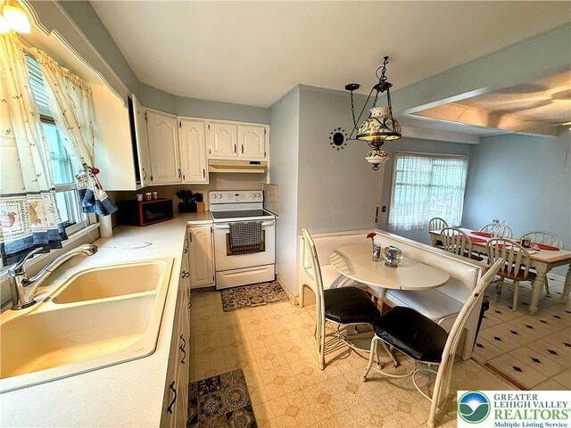 213 Main St, Pen Argyl Borough, PA 18072 - kitchen with electric range, under cabinet range hood, a sink, light floors, and light countertops