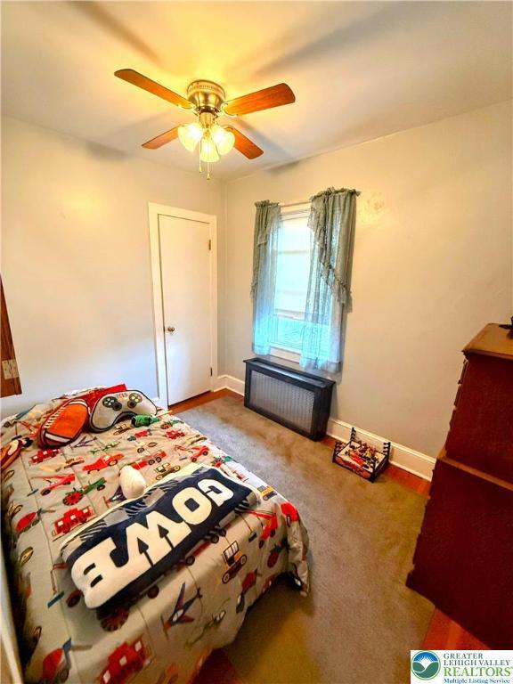 213 Main St, Pen Argyl Borough, PA 18072 - carpeted bedroom featuring radiator, a ceiling fan, and baseboards