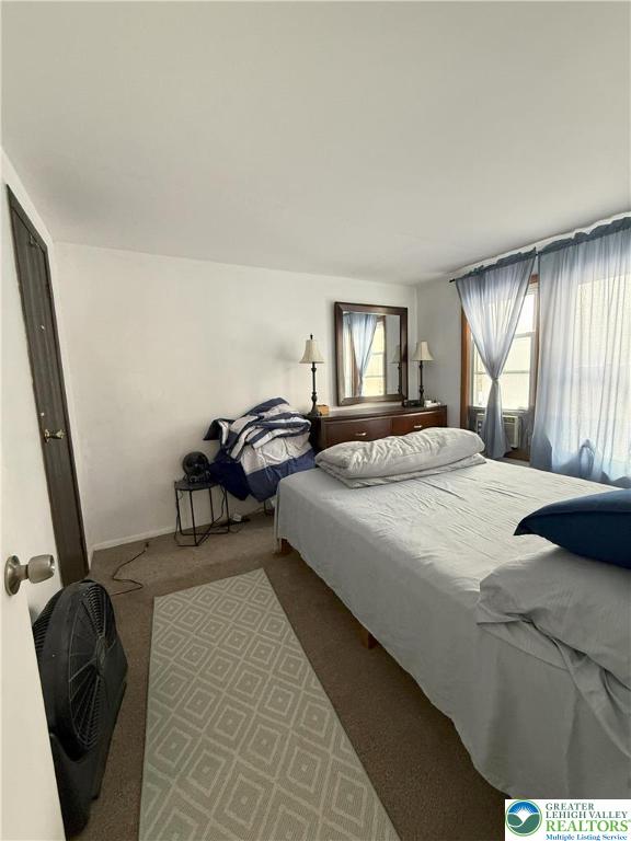 bedroom with carpet flooring and baseboards