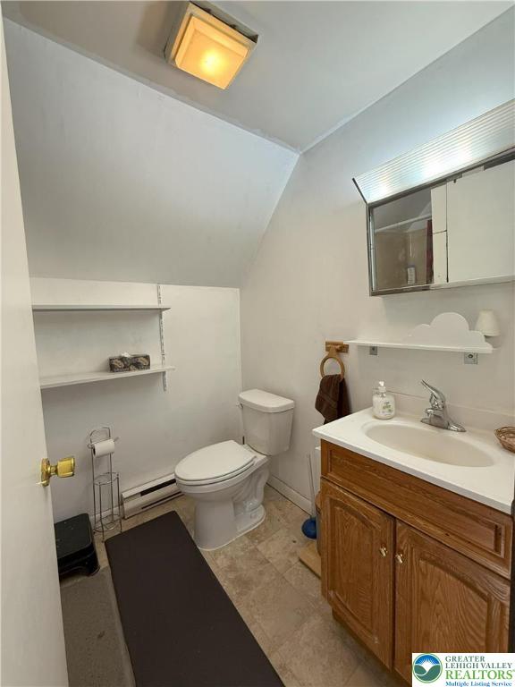 bathroom with vaulted ceiling, toilet, a baseboard radiator, and vanity