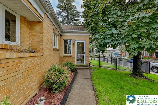 doorway to property featuring brick siding