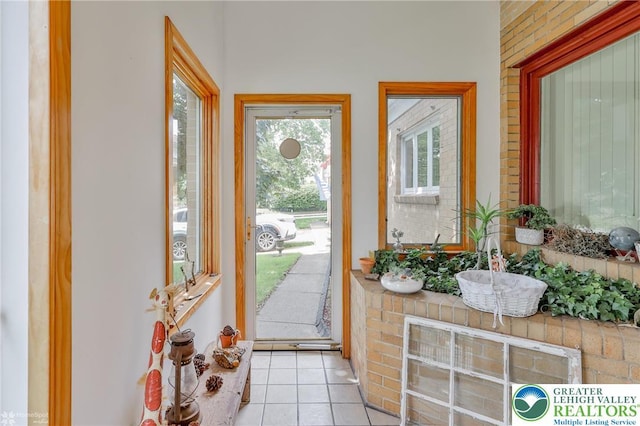 doorway to outside featuring light tile patterned floors