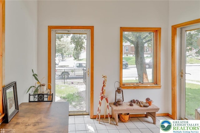 entryway featuring light tile patterned flooring and baseboards
