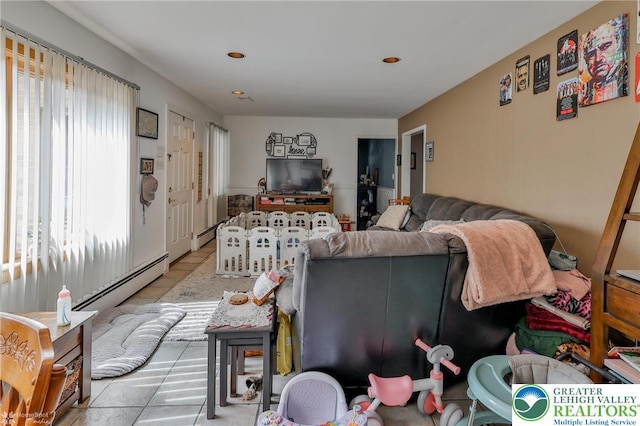 living area featuring a baseboard radiator, tile patterned flooring, and recessed lighting