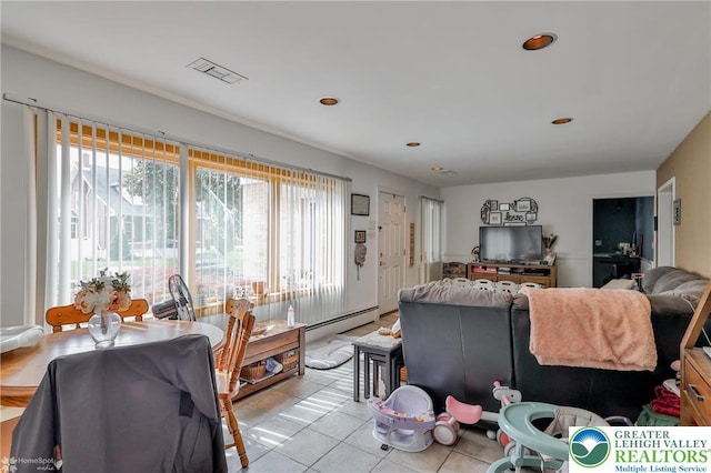 living area featuring light tile patterned floors, a baseboard radiator, and recessed lighting