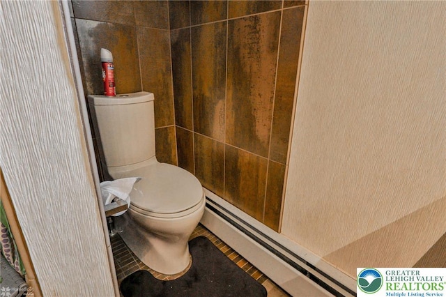 bathroom featuring a baseboard radiator, toilet, and tile patterned flooring