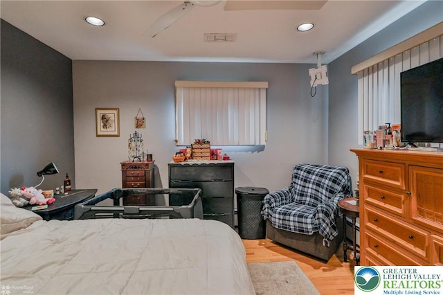 bedroom with wood finished floors and recessed lighting