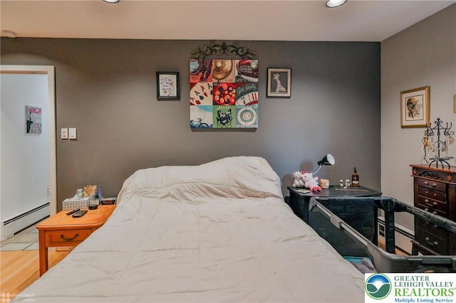 bedroom with baseboard heating, recessed lighting, and wood finished floors