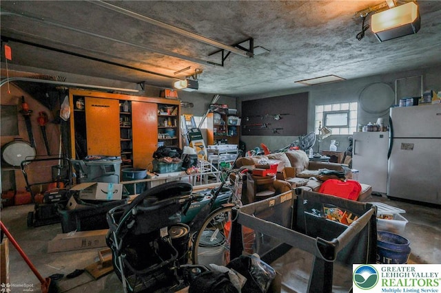 garage with freestanding refrigerator and a garage door opener