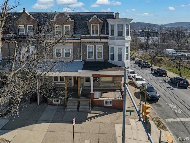 view of front of house with a mountain view and a porch