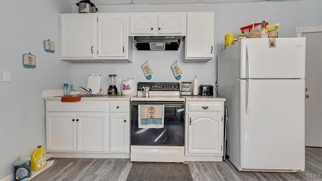 kitchen with freestanding refrigerator, exhaust hood, electric stove, light wood-style flooring, and white cabinetry