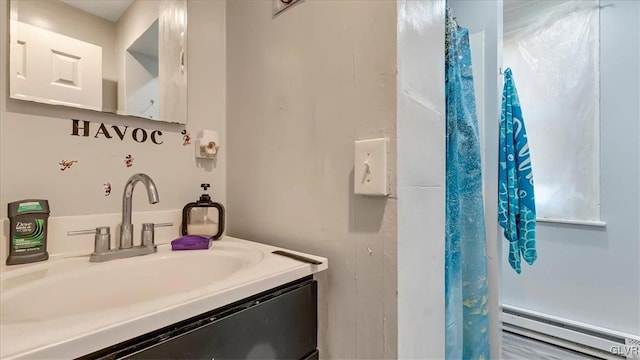 bathroom with a baseboard radiator and vanity