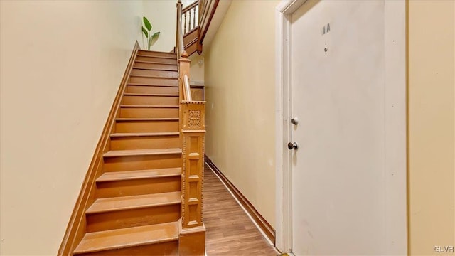 staircase with wood finished floors