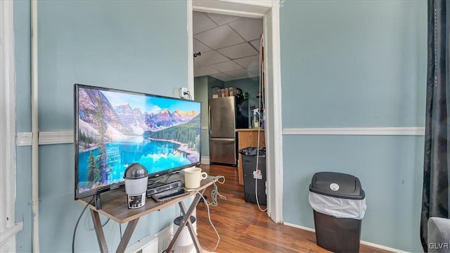 office space featuring a drop ceiling and wood finished floors