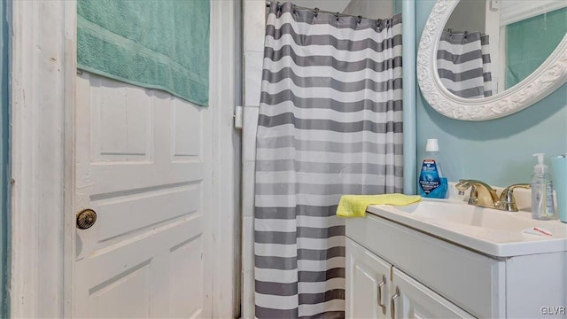 bathroom featuring vanity and a shower with shower curtain