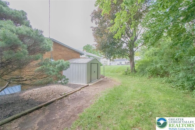 1115 N 38th St, South Whitehall Twp, PA 18104 - view of grassy yard with a storage unit and an outdoor structure