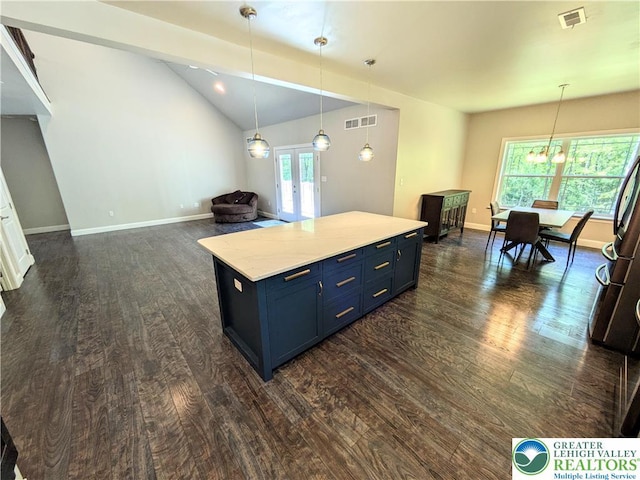 130 Corktree Rd, Polk Twp, PA 18058 - kitchen with dark wood-style floors, blue cabinetry, vaulted ceiling, refrigerator, and baseboards