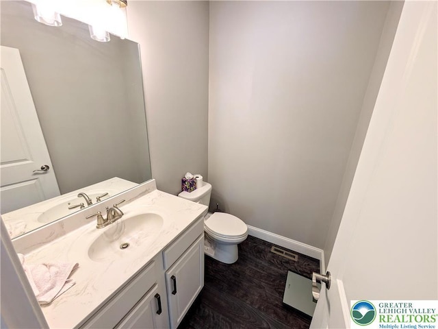 130 Corktree Rd, Polk Twp, PA 18058 - half bathroom with toilet, vanity, wood finished floors, and baseboards