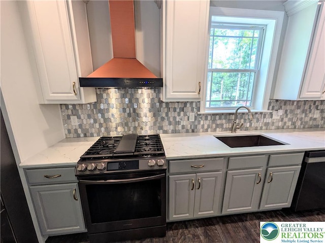 130 Corktree Rd, Polk Twp, PA 18058 - kitchen with stainless steel gas range, wall chimney exhaust hood, a sink, gray cabinets, and dishwasher