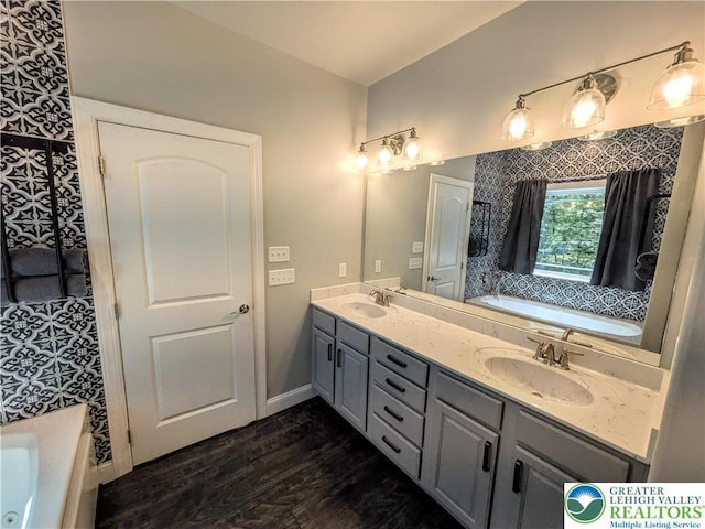 130 Corktree Rd, Polk Twp, PA 18058 - full bath featuring a bath, wood finished floors, double vanity, and baseboards